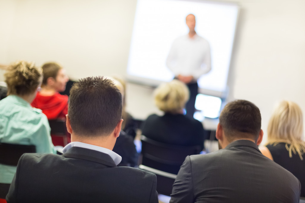 A speaker giving a lecture to professionals